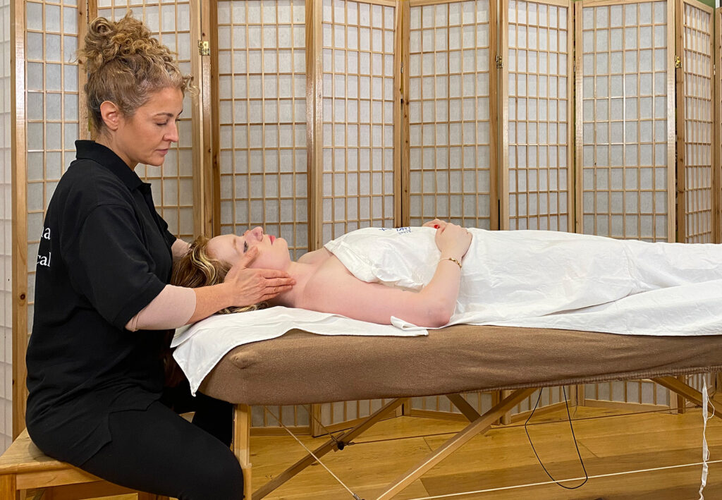 Mariana Arando demonstrating the Manual Lymphatic Drainage treatment on a client