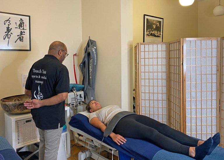 A client at the Touch Tuina Kentish Town clinic being given a bemer Therapy treatment by Errol Lynch